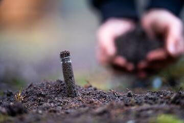 agronomist on a farm practicing agronomy holding soil, doing soil tests in her home laboratory....