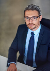 Office, portrait and confident businessman at desk with opportunity, trust and legal advice at law firm. Lawyer, attorney and mature man with professional pride, about us and consultant at agency