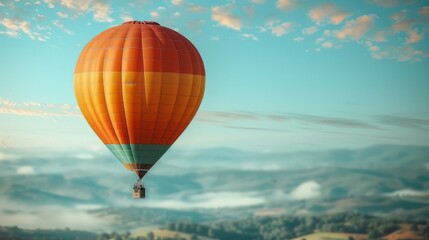 Fototapeta premium An orange and green hot air balloon glides through the sky