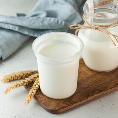 Creamy natural yogurt in a simple white container, perfect for a healthy and nutritious snack.