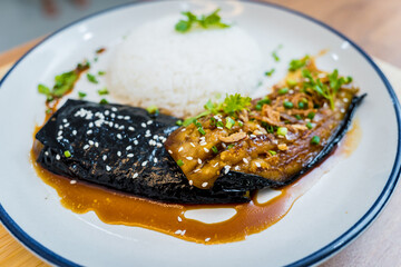 Delicious grilled eggplants with garlic on the white plate