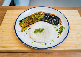 Delicious grilled eggplants with garlic on the white plate
