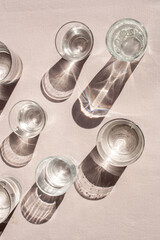 Glasses with water and contrasting shadows. Lifestyle. View from above