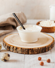 Natural sour cream in a plastic cup made from farm milk. Fermented milk products