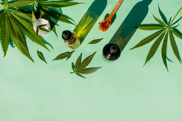 Hemp leaf for cosmetic purposes. Marijuana oil and cream on a menthol background. Cosmetics,...