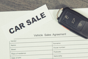 Car key, inscription car sale and vehicle sales agreement. Sales, purchases of automobile....