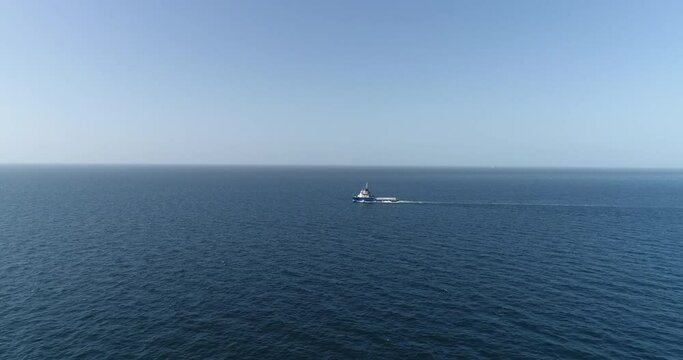  An oil industry vessel sails on the blue sea during the day, captured by a drone