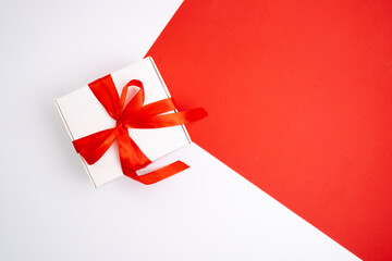 Gift box with a bow on a colored background. Happy Holidays, gift box close-up. Boxing Day...
