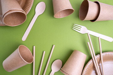 Kraft paper tableware: cups, food boxes, isolated on a light background. A set of various...