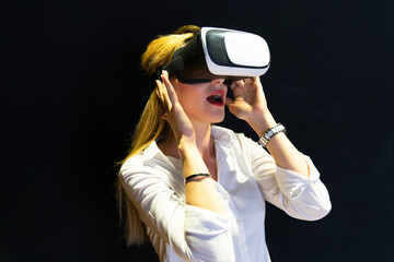 A woman is playing a video game with a virtual reality headset. Business woman wearing virtual reality headset