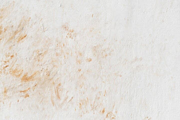 Dirty old uneven render white paint concrete wall with cat footprint or paw print red soil stains....