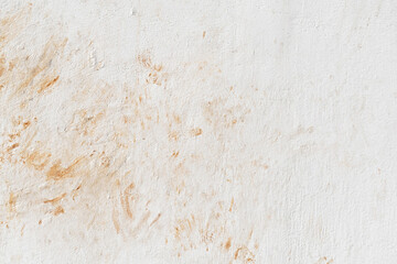 Dirty old uneven render white paint concrete wall with cat footprint or paw print red soil stains. Grunge and rough surface. 