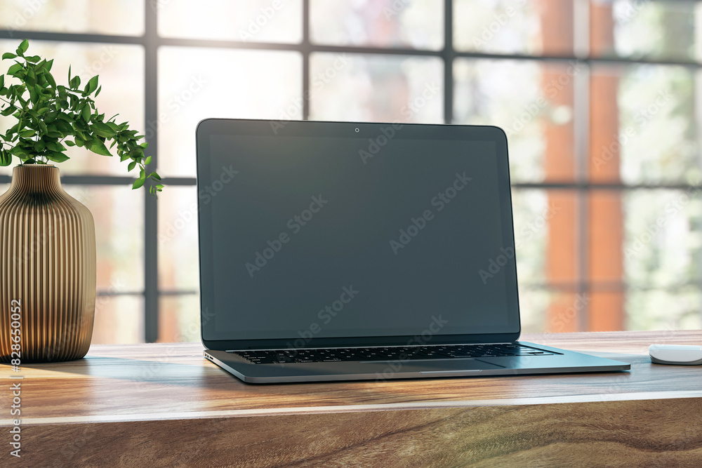 Poster laptop with a blank screen on a wooden desk, office setting with a plant, concept of workspace. 3d r