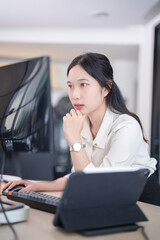 Investor businesswoman standing and reading business stock data on computer while working about stock and marketing of new startup to analysis trade and investment of business project in office