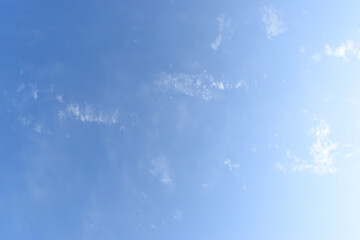 beautiful blue sky and white fluffy group of clouds with sunrise in the morning, natural background