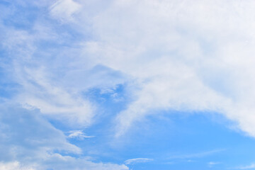 beautiful blue sky and white fluffy group of clouds with sunrise in the morning, natural background
