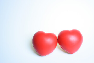 two red stress ball isolated on white background, heart shape toy