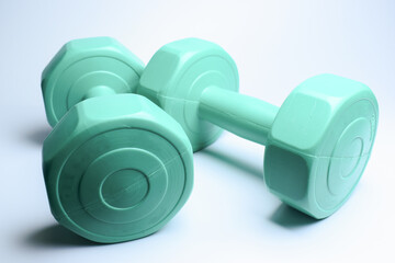 two green dumbbell on white background, object for exercise