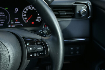 interior view of car with black leather, steering wheel with button