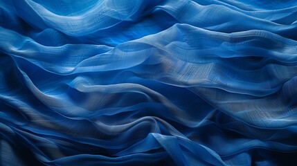 Obraz premium Blue flowing silk fabric with waves and ripples. Soft and smooth, it cascades in gentle folds.