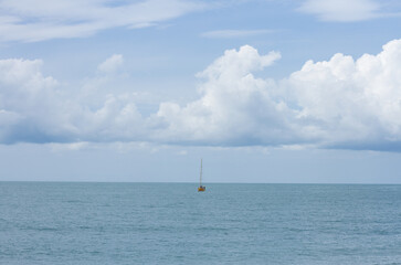 Small sailboat in the black sea. Summer seascape