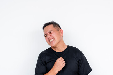 A man feeling uncomfortable from the heat, perspiring from the hot temperature. Summer concept,...
