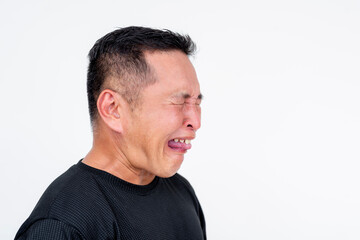 Obraz premium Side view of a middle-aged Asian man unable to contain himself after eating something sour, isolated on a white background.