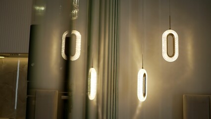 Interesting chandeliers in the room, close-up. Two modern decorative pendant lamps.