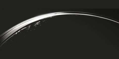stylized image of a thin white ragged slash arc all the way across the frame diagonally. Black background