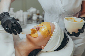  A girl at a cosmetologist does cosmetic procedures. Alginate mask