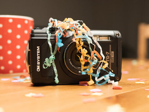 OM System TG-7 on a party table with confetti on top for party photography