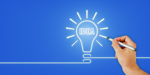 Hand drawing an illuminated light bulb with the word IDEA on a blue background, symbolizing...