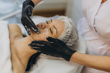 A girl at a cosmetologist does cosmetic procedures. Skin cleansing