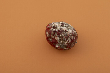 Ugly moldy passion fruit. Rotten spoiled food. Concept - Improper food storage. Reduction of organic waste