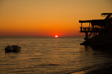Sunset sky over sea in the Evening with orange sunlight