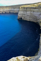 High vertical rocky shore on the island of Gozo, Malta