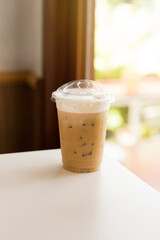 A refreshing iced cappuccino in a clear plastic cup.