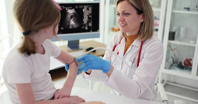 Child patient with orthopedic doctor in office. Ultrasound of elbow joint in children