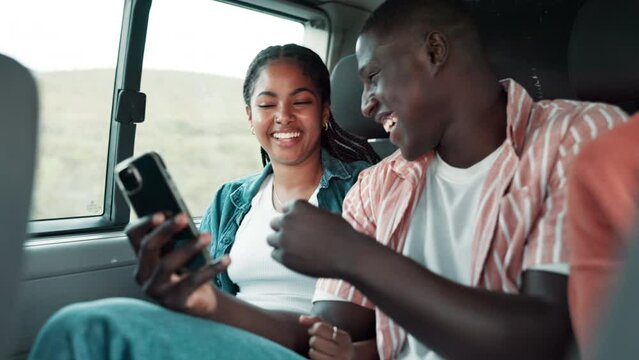 Phone, travel and couple in van on road trip laughing at funny, comic or comedy joke online. Technology, drive and African man and woman watching video together on cellphone for holiday journey.