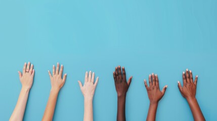 Colorful cut out paper hands of different skin colors reaching up on a blue background.