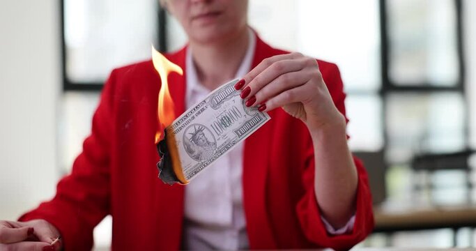 Seo boss burning million US dollar banknote closeup. Inflation devaluation and default