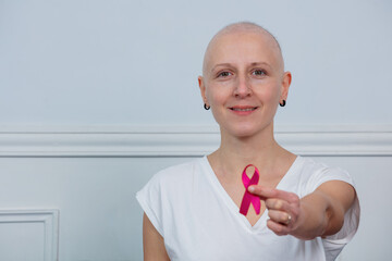 Woman with ribbon supports cancer awareness, smile empowering