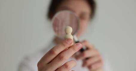 Girl agent looks through magnifying glass. Searching for employees in company and recruiting