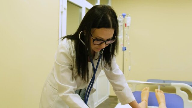 Dummy model for teaching medical practice. Mannequin for students of medical universities studying at the faculties of medical. The teacher listens to the mannequin.