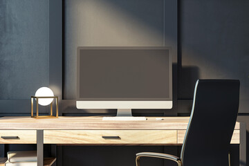 Fototapeta premium Modern desktop computer on a wooden desk with a lamp, in front of a dark wall, concept of a workspace. 3D Rendering