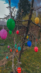 Easter joy blossoms around a tree adorned with vibrant Easter eggs, radiating the spirit of...