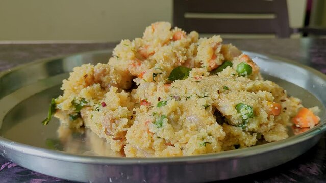 Close-up video of healthy homemade Indian breakfast broken wheat porridge or upma
