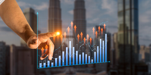 An arm interacting with digital growth chart, superimposed on cityscape, depicting a concept of business analysis