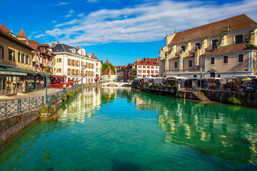 Annecy old town with medieval architecture reflecting in the lake water.