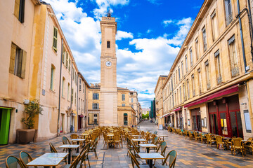 Restaurant street in Nimes and church tower view, south of France